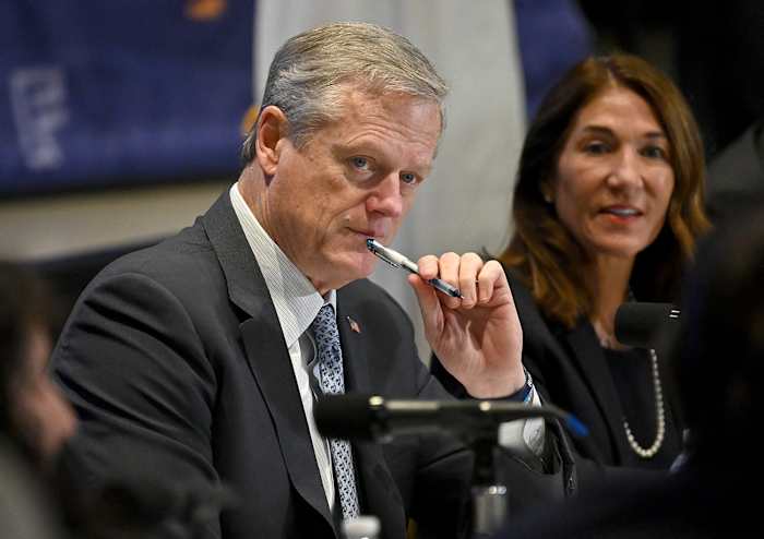 Charlie Baker listens to a presentation.